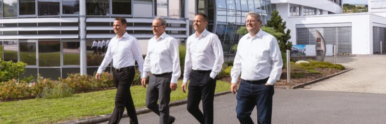Management runs in front of the company building