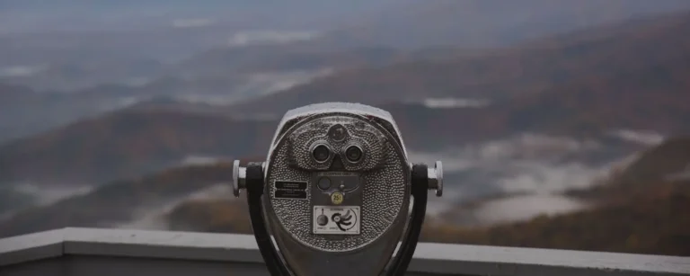 Binoculars with mountains in the background